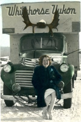 Anne posing on front bumper of dog team truck from Alaska. Athabasca, 1945. Anne posing on front bumper of dog team truck from Alaska. Athabasca, 1945.