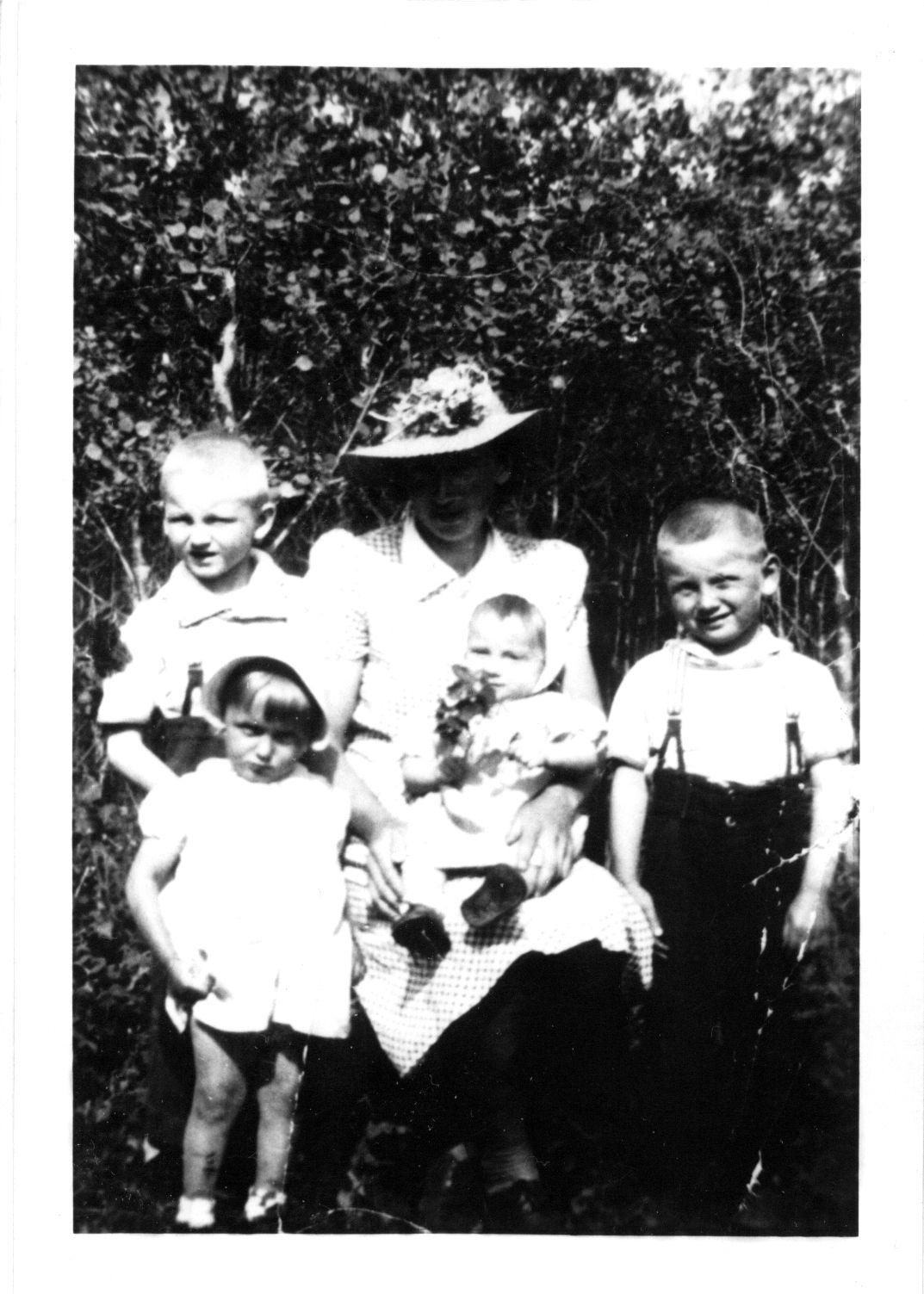 Left to right: Ted, Annie Turkawski (mother), Mike, Victoria, and Evangeline. Circa 1944. Left to right: Ted, Annie Turkawski (mother), Mike, Victoria, and Evangeline. Circa 1944.