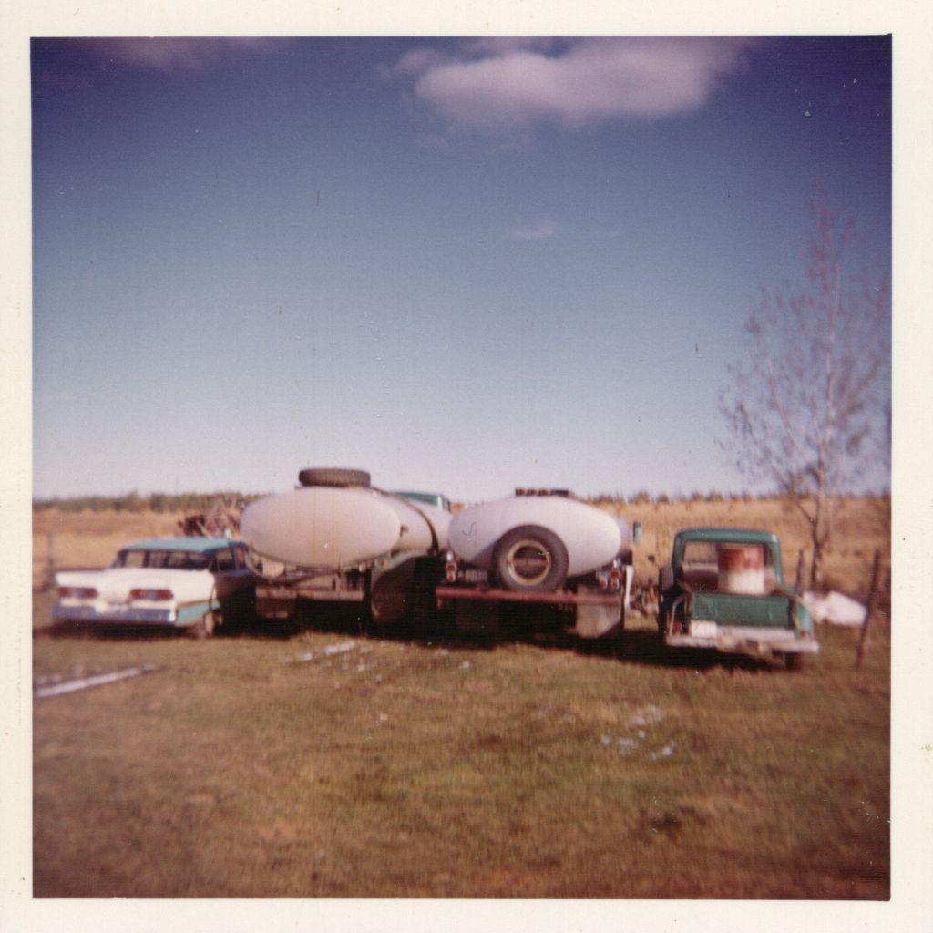 Ted and his business. Grain stooks on his parents' farm in background field. Autumn, 1964. Ted and his business. Grain stooks on his parents' farm in background field. Autumn, 1964.