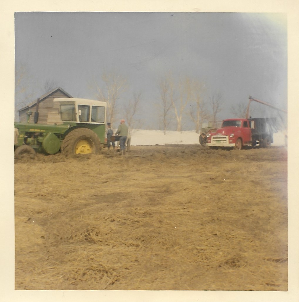 Granaries, equipment and ruts in creek back-up soaked farm yard - 1969 - #4